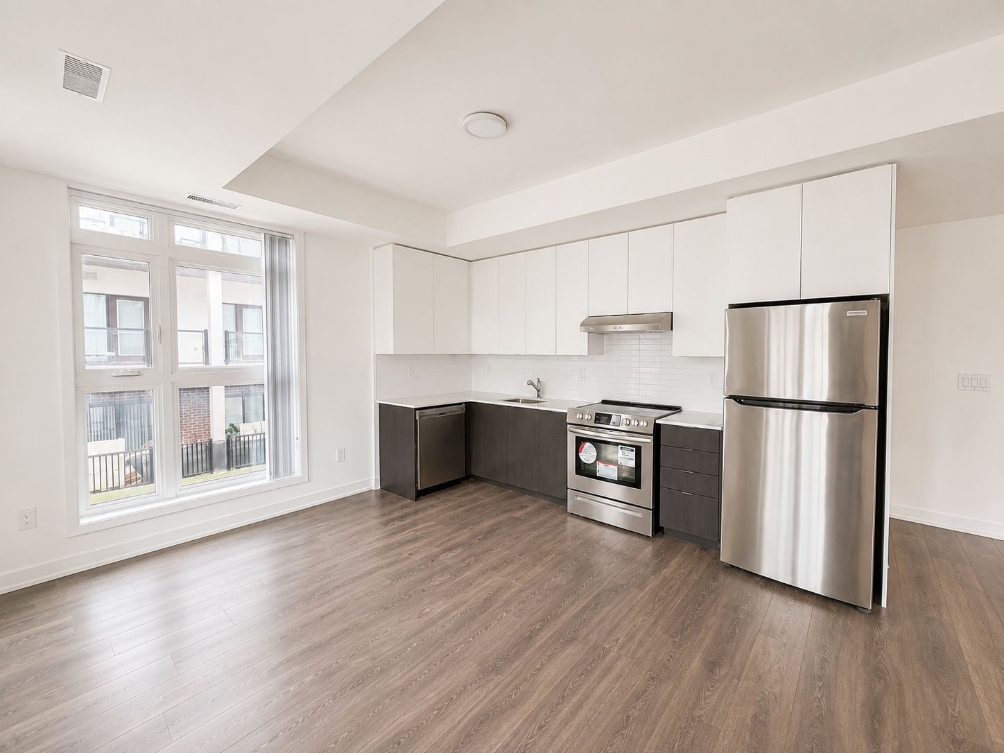 Modern kitchen with stainless steel appliances and quartz counters