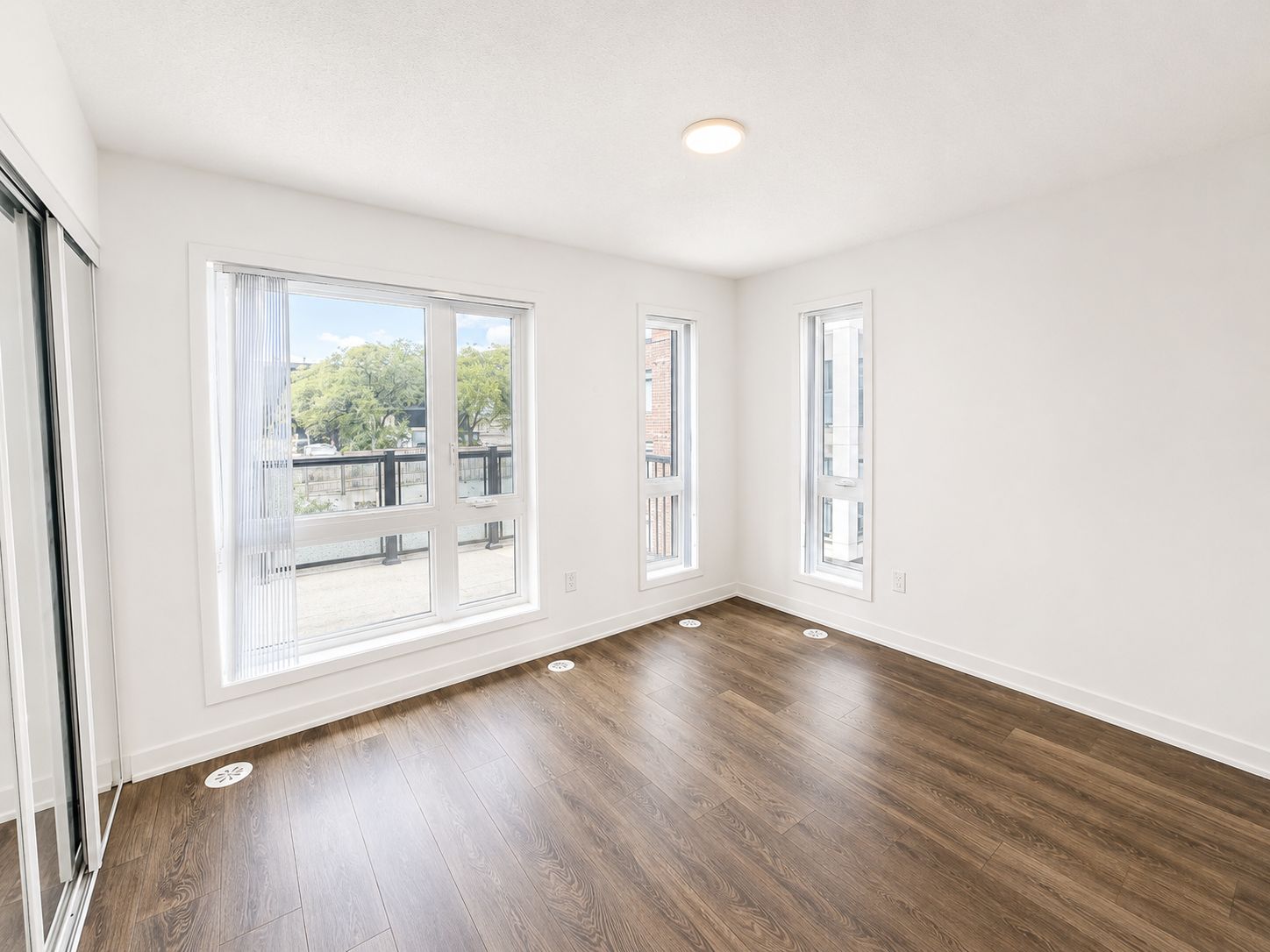 Bright corner living room with windows to the balcony